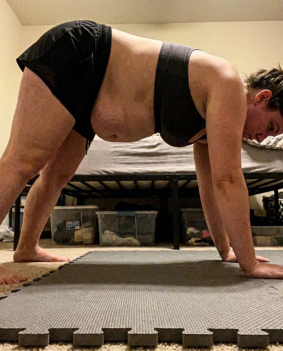 Woman doing a plank with her belly doming into a point